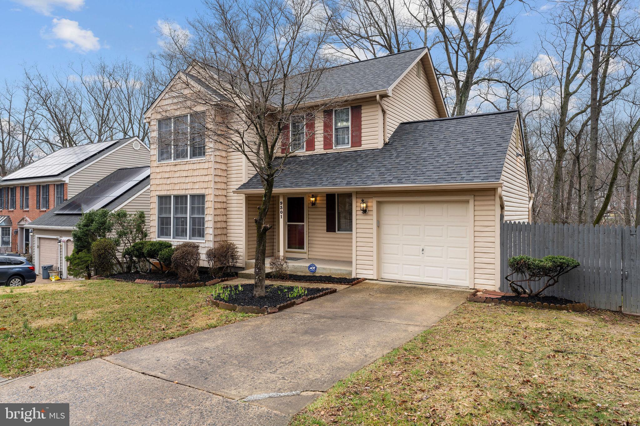 9301 Bellbeck Road Baltimore, MD 21234 - Photo 2 of 35 a front view of a house with a yard and garage