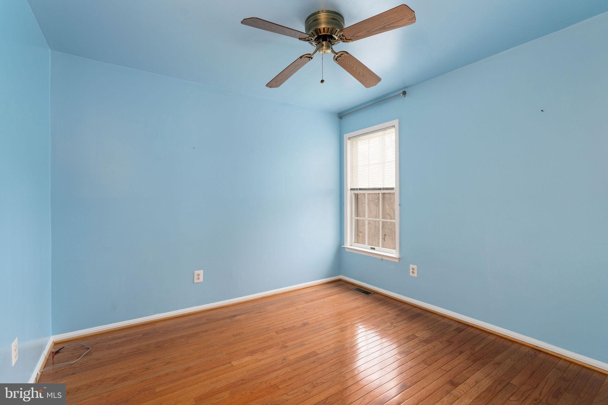 9301 Bellbeck Road Baltimore, MD 21234 - Photo 23 of 35 an empty room with a window and a fan