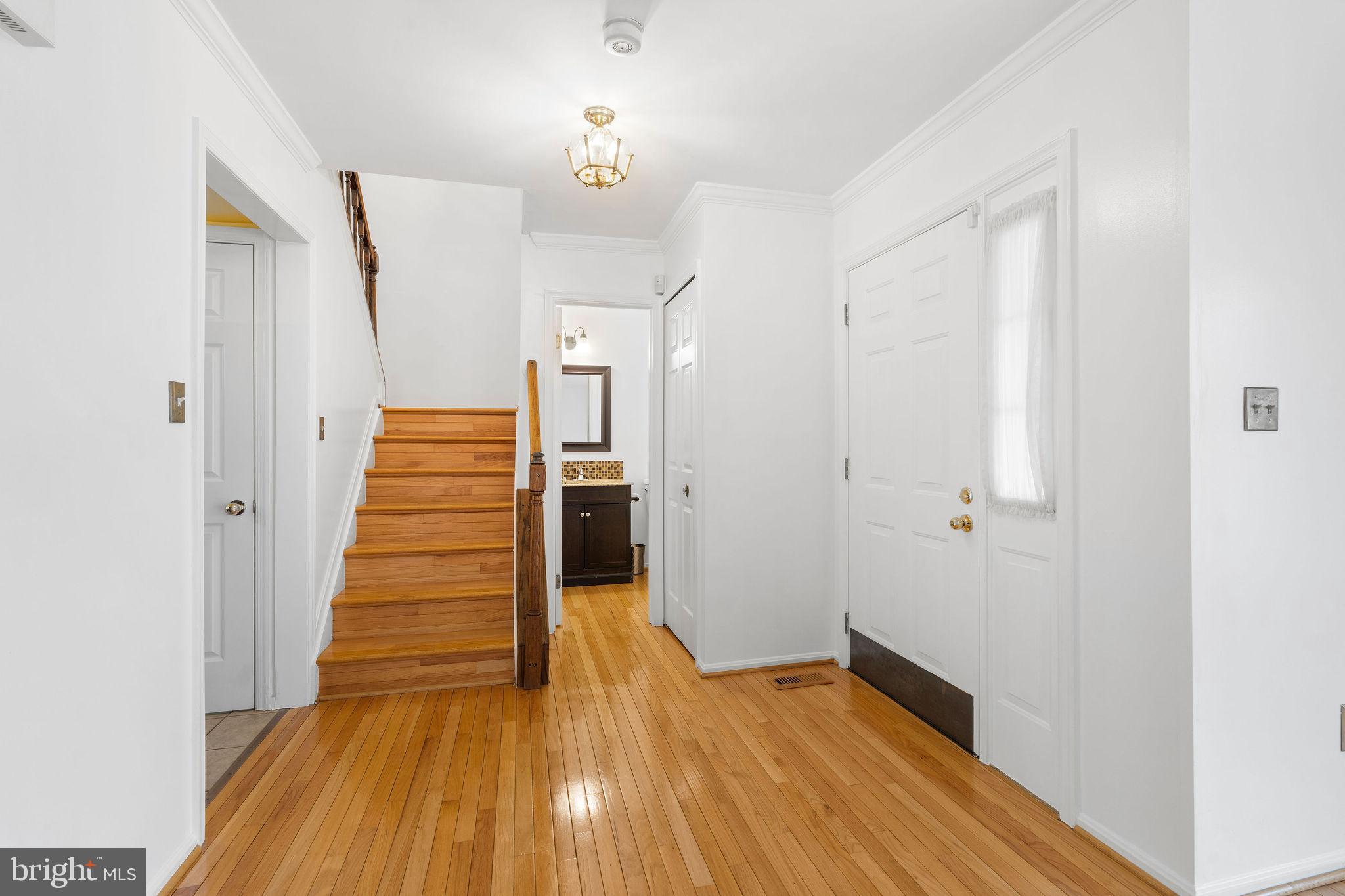 9301 Bellbeck Road Baltimore, MD 21234 - Photo 3 of 35 a view of a hallway with wooden floor and entryway