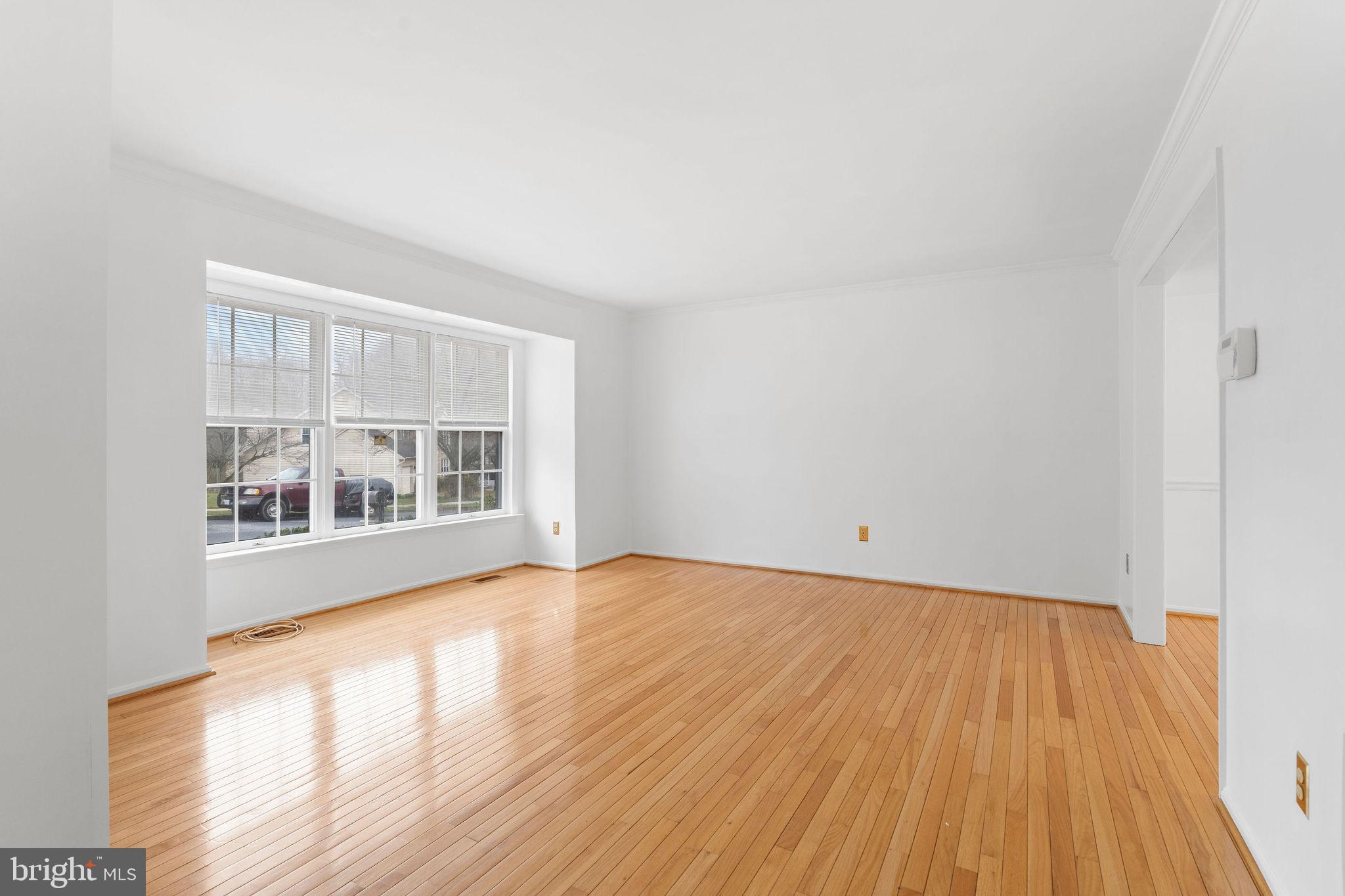 9301 Bellbeck Road Baltimore, MD 21234 - Photo 4 of 35 a view of empty room with wooden floor and fan