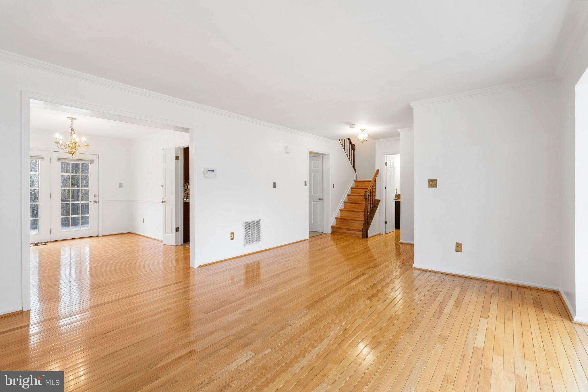 9301 Bellbeck Road Baltimore, MD 21234 - Photo 5 of 35 a view of an empty room with wooden floor and a window