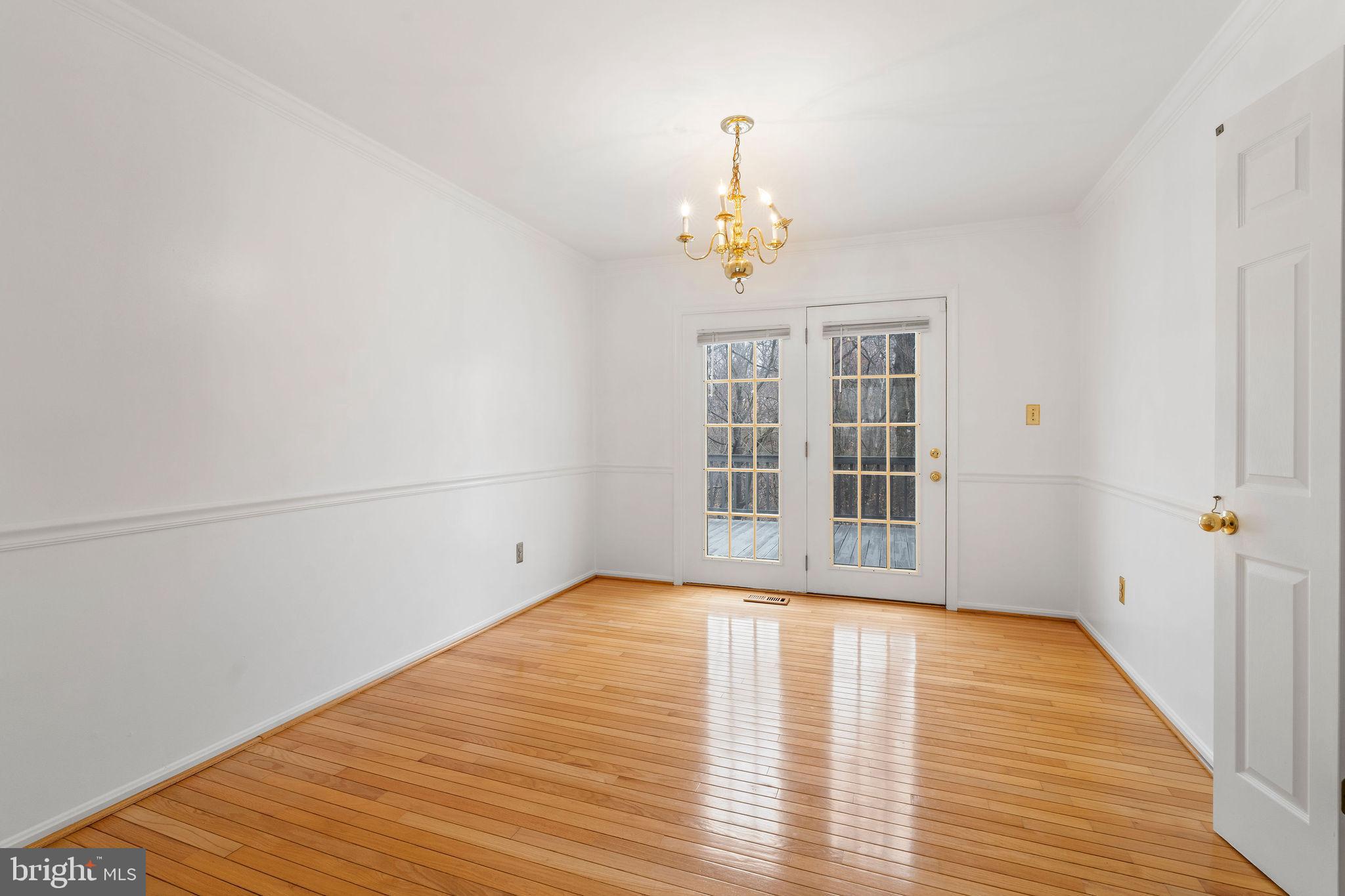 9301 Bellbeck Road Baltimore, MD 21234 - Photo 6 of 35 a view of empty room with wooden floor and fan
