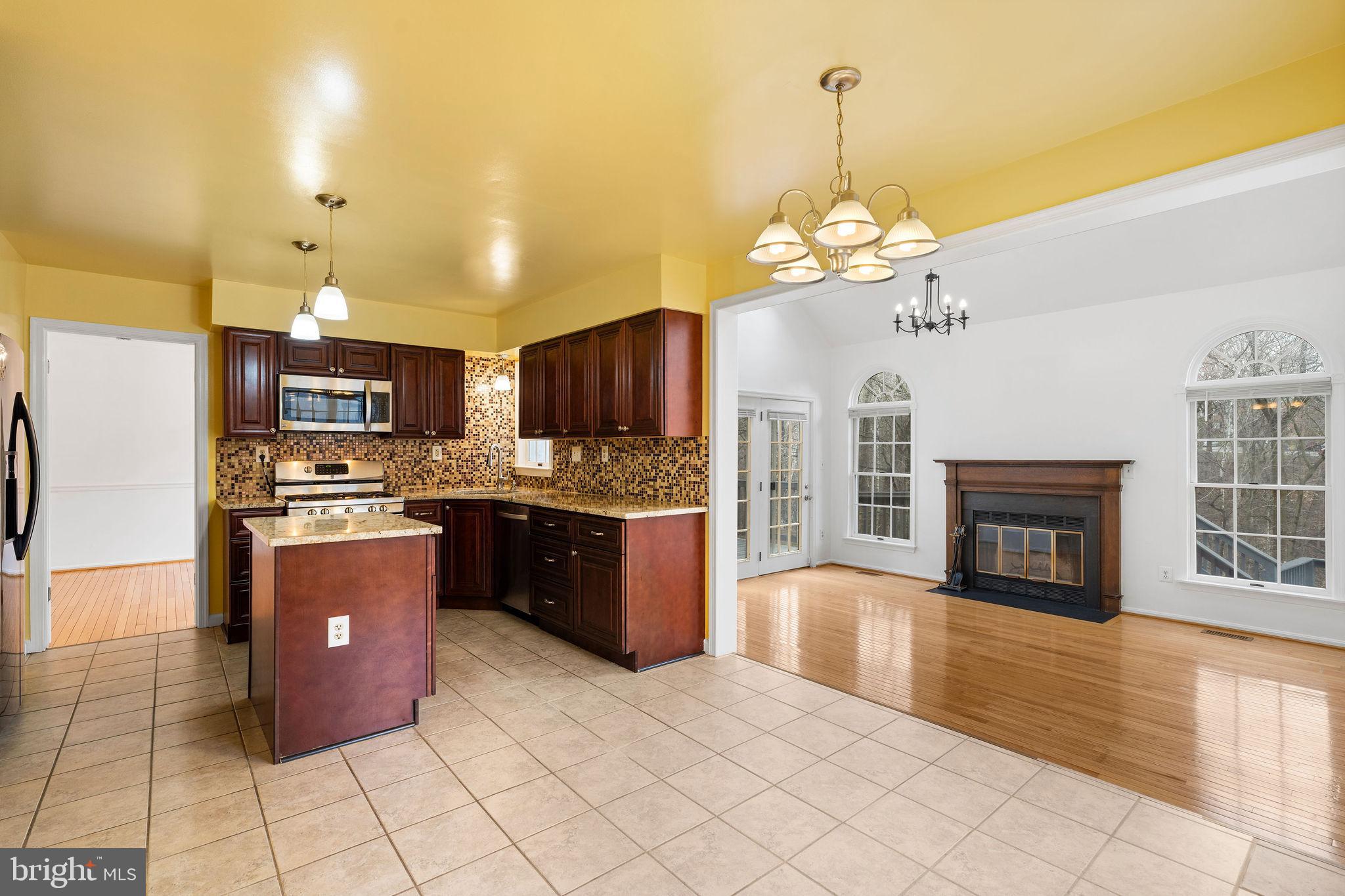 9301 Bellbeck Road Baltimore, MD 21234 - Photo 9 of 35 a large kitchen with chandelier and stainless steel appliances