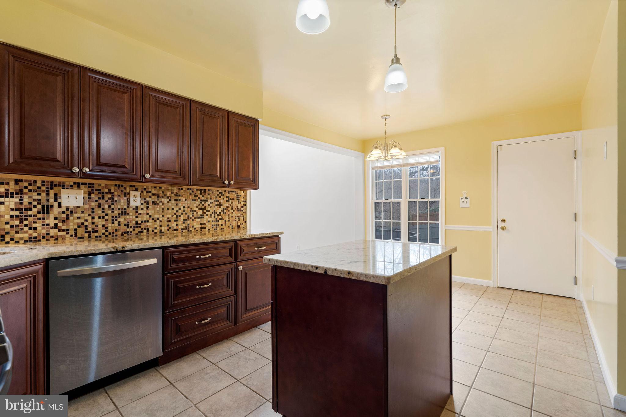 9301 Bellbeck Road Baltimore, MD 21234 - Photo 10 of 35 a kitchen with granite countertop a cabinets and steel stainless steel appliances