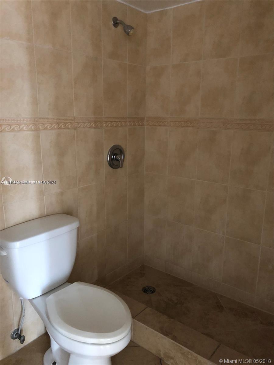 16909 North Bay Road, Unit 711 Sunny Isles Beach, FL 33160 - Photo 6 of 9 a toilet sitting next to a bathroom sink