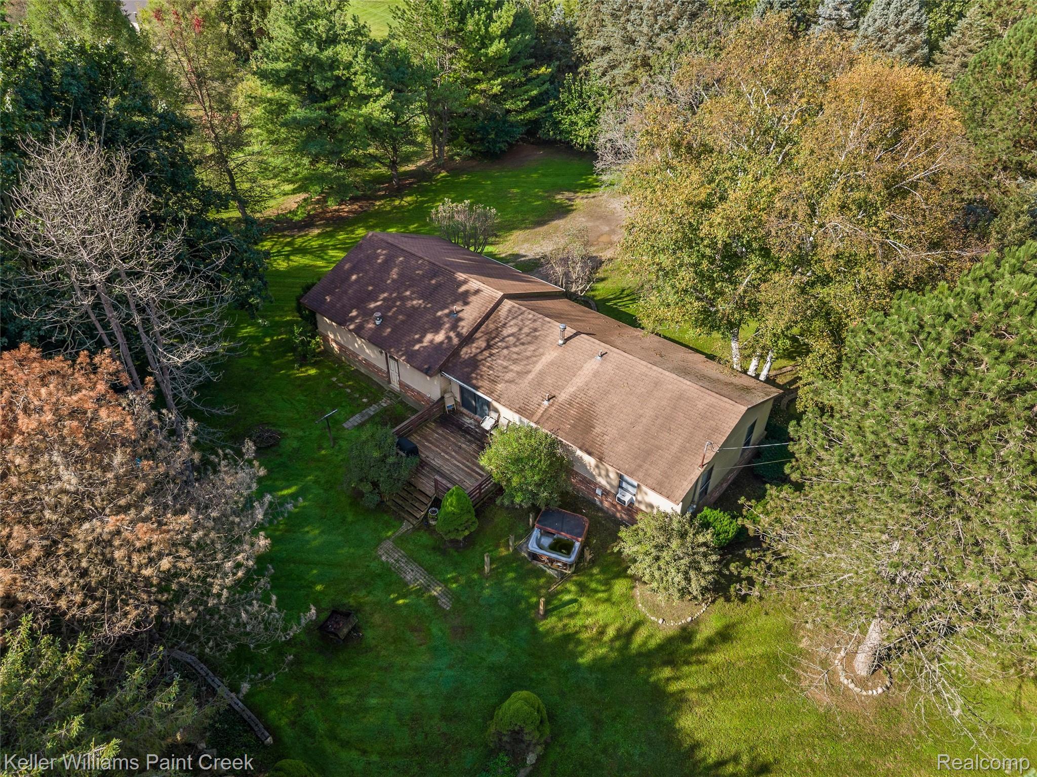 5077 Pinckney Road Howell, MI 48843 - Photo 37 of 39 Expansive property featuring mature trees, a multi-level wood deck, and lush green landscaping