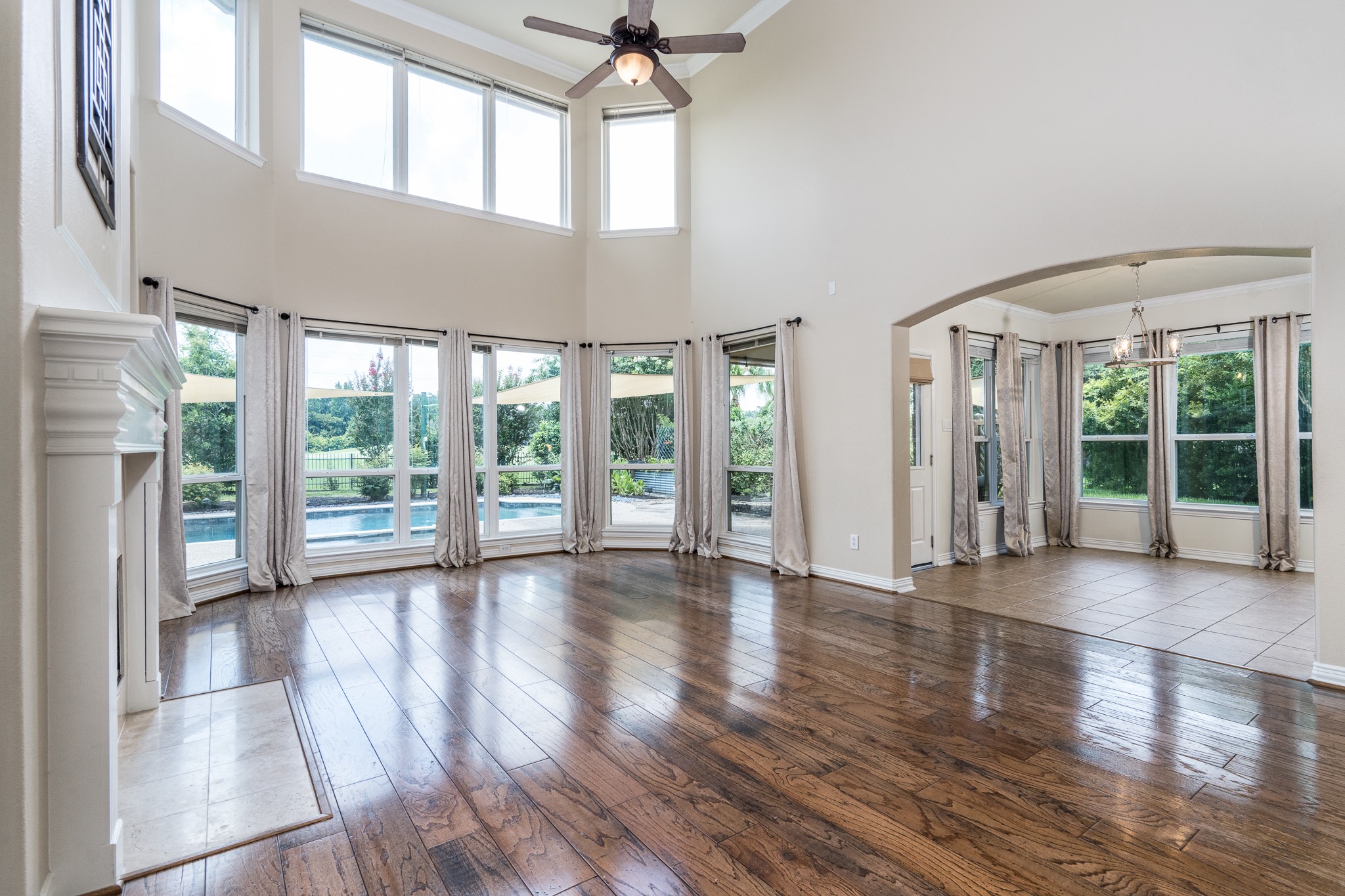 5914 Oakmoss Trail Spring, TX 77379 - Photo 50 of 50 Gorgeous wood flooring flows from the entry into the main living areas! This open floor plan is perfect for entertaining or just spending the evenings relaxing with the family! Crown molding and a wall of windows add to the classic design! High ceilings can be found throughout the home creating a open feel!...