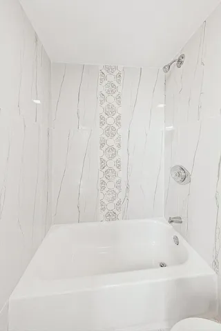 a bathroom with a bathtub and shower