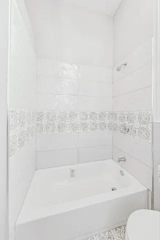 a bathroom with a bathtub and toilet