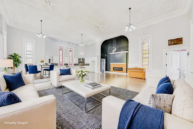 a living room with furniture and a chandelier