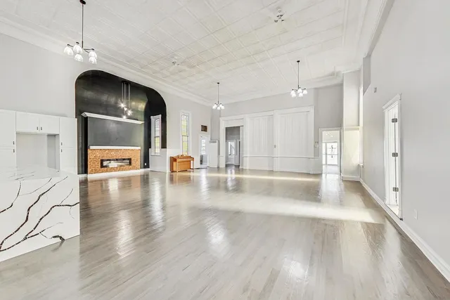 a view of a living room a kitchen and a chandelier