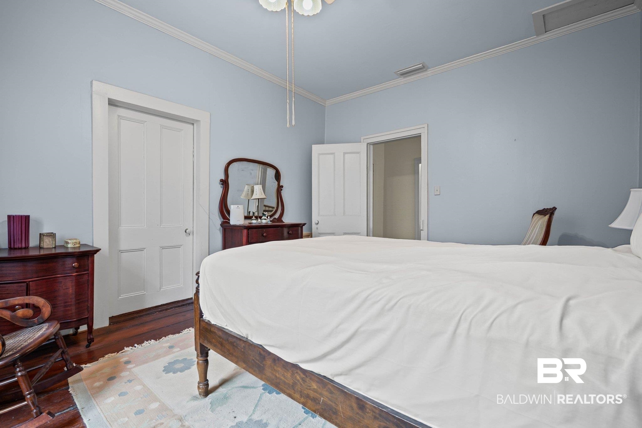 23561 Main Street Fairhope, AL 36532 - Photo 27 of 45 Bedroom with crown molding and dark wood-style flooring