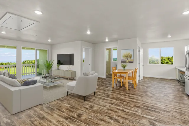 a living room with furniture a large window and a table