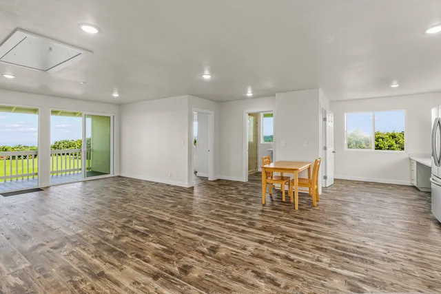 a view of a livingroom with furniture window and wooden floor