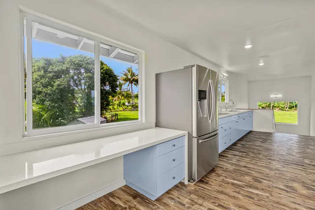 a kitchen with stainless steel appliances granite countertop a refrigerator and a sink