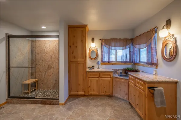 a bedroom with furniture and a large window