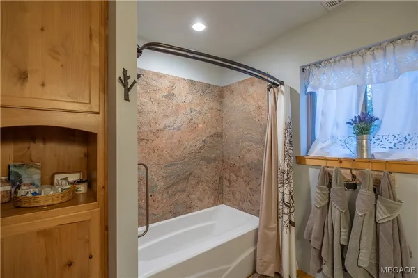 a bedroom with two beds and a chair