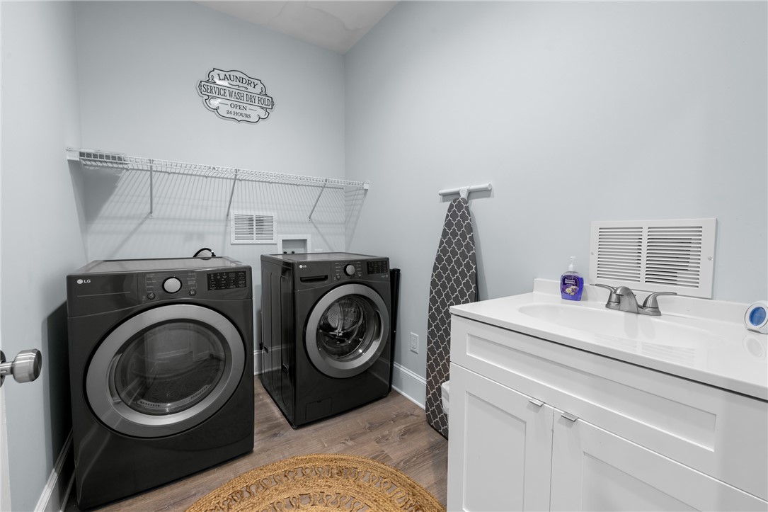 206 Petty Road Seneca, SC 29672 - Photo 15 of 47 A dedicated utility space with contemporary washer and dryer units for household efficiency.