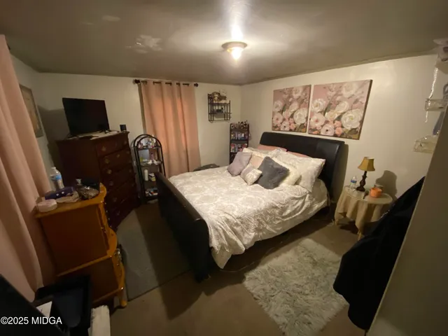 a bedroom with a bed a desk and chair