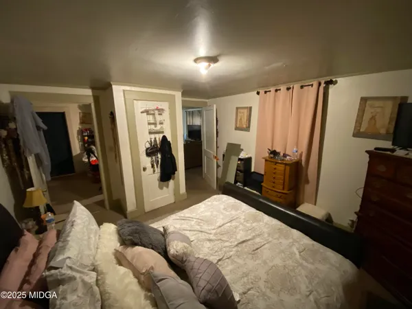 a bed room with a bed and a mirror