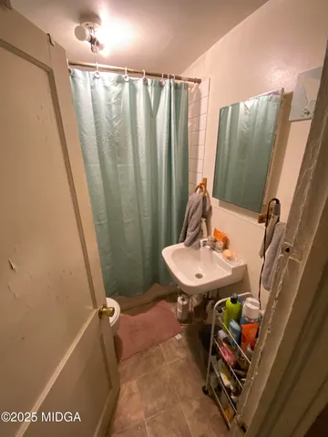 a bathroom with a sink a toilet and tub