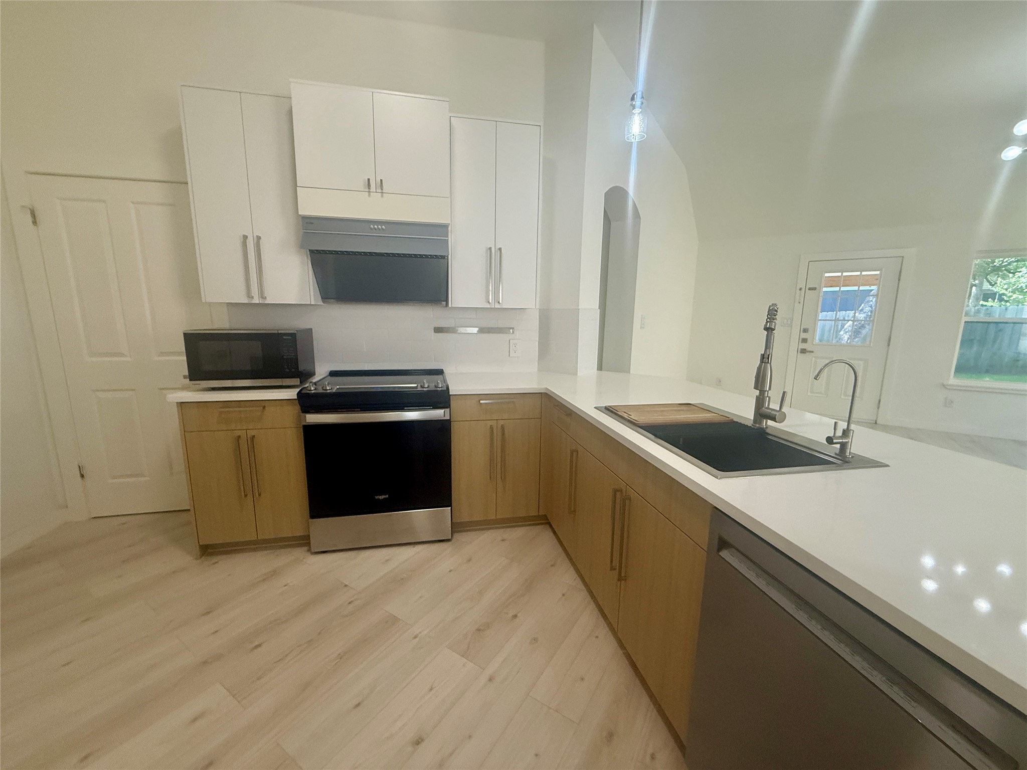 a kitchen with stainless steel appliances granite countertop a sink and a stove