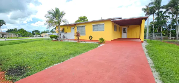 a front view of house with yard and outdoor seating