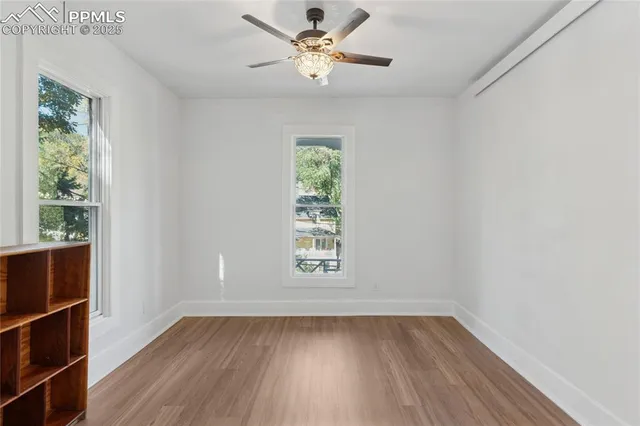 wooden floor in an empty room with a window