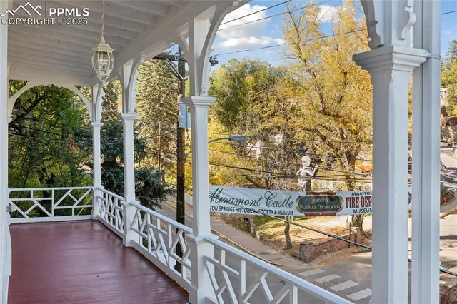 a view of balcony with two large trees