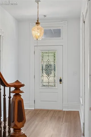 a view of a room with wooden floor and windows