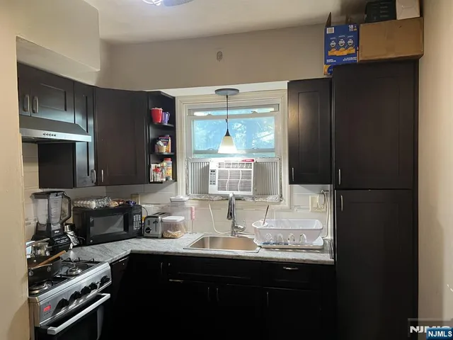 a kitchen with a sink and cabinets