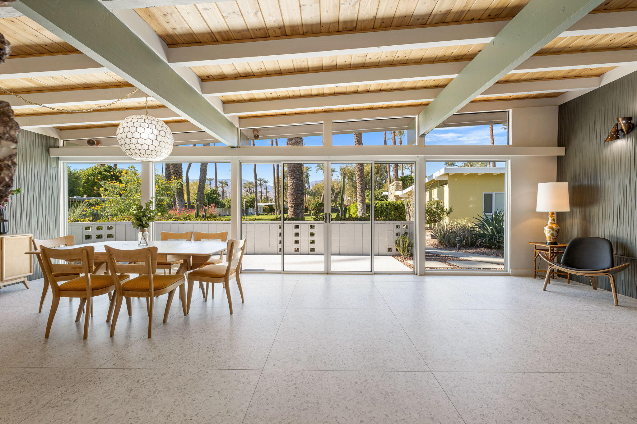 a dining room with furniture and a floor to ceiling window