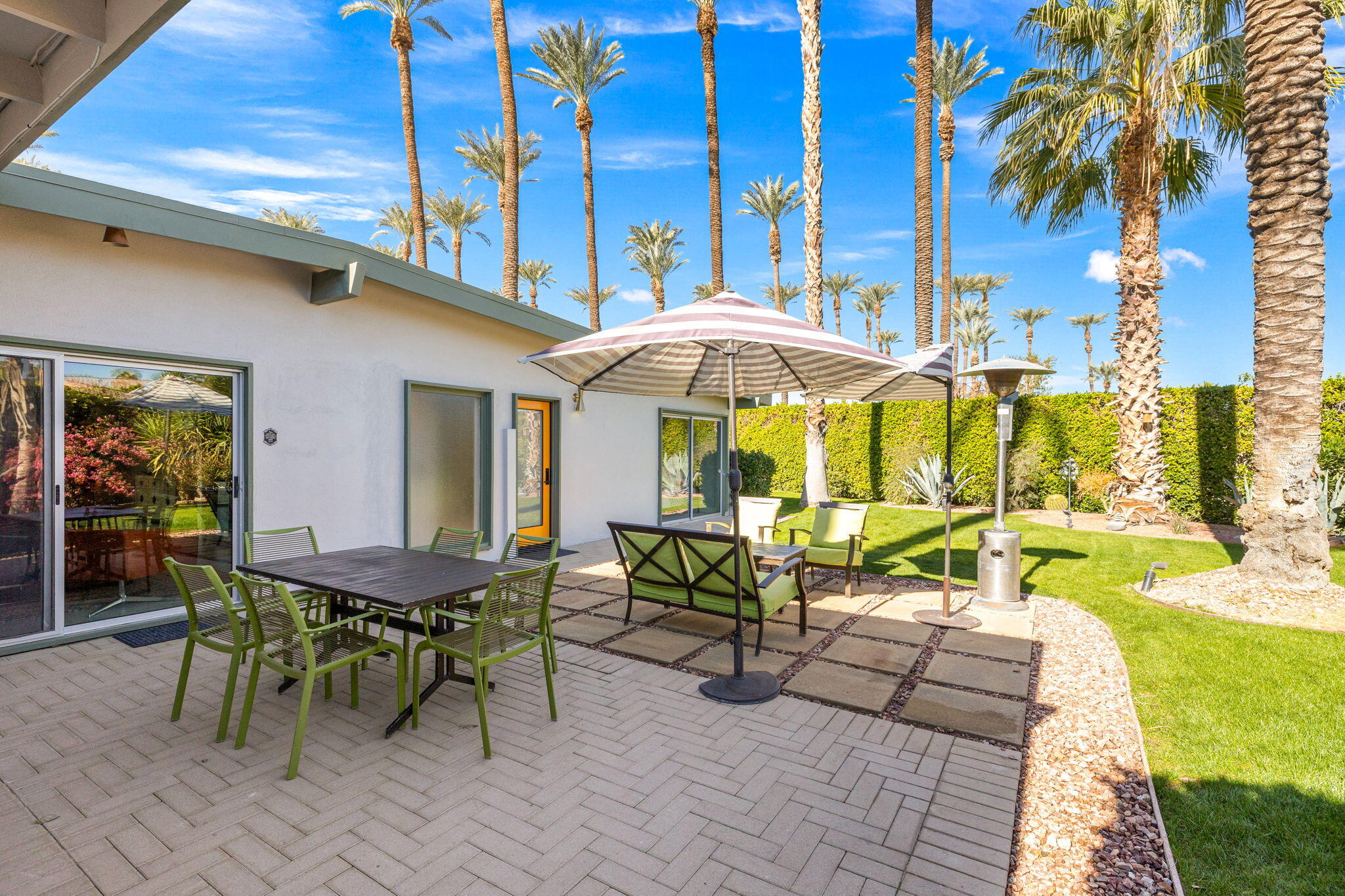 36903 Palm View Road Rancho Mirage, CA 92270 - Photo 36 of 58 a view of a patio with a table and chairs under an umbrella
