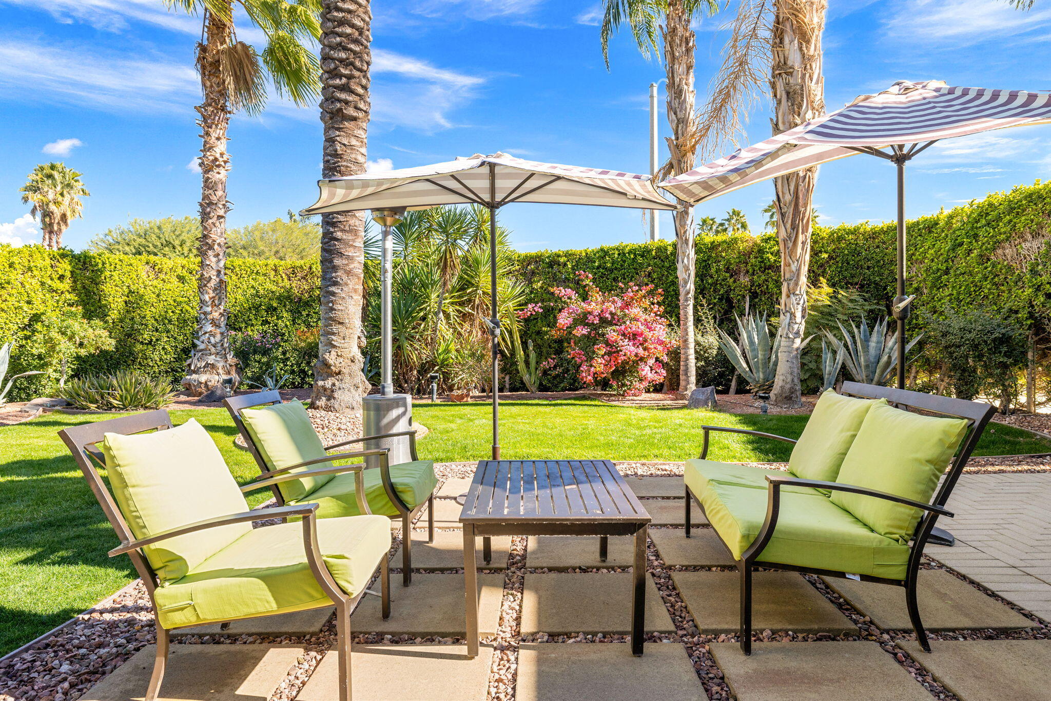 36903 Palm View Road Rancho Mirage, CA 92270 - Photo 37 of 58 a view of an chairs and table in the patio and a garden