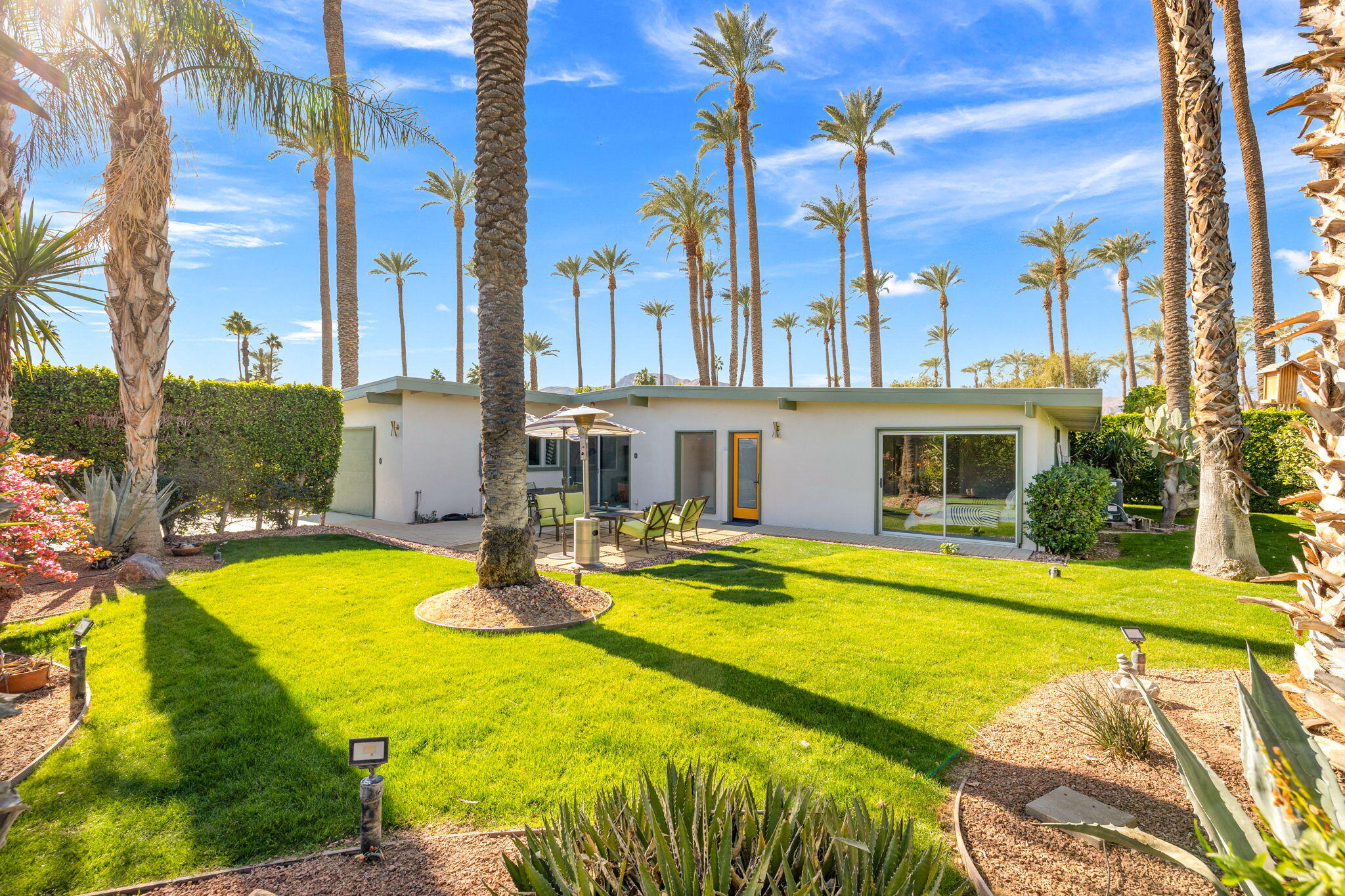 36903 Palm View Road Rancho Mirage, CA 92270 - Photo 41 of 58 a view of a swimming pool with a lawn chairs under an umbrella