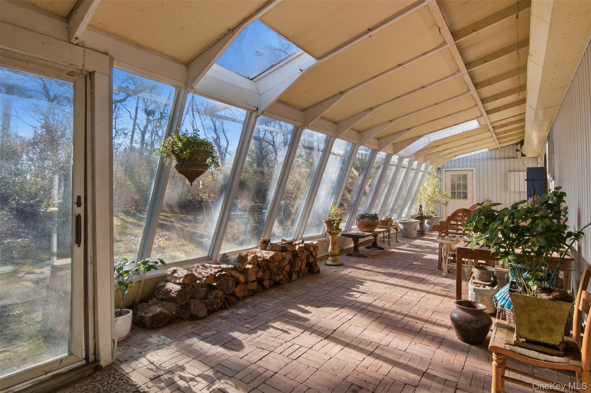 8 Old Wood Road Stony Brook, NY 11790 - Photo 11 of 50 Sunroom / solarium featuring a skylight, vaulted ceiling, and plenty of natural light