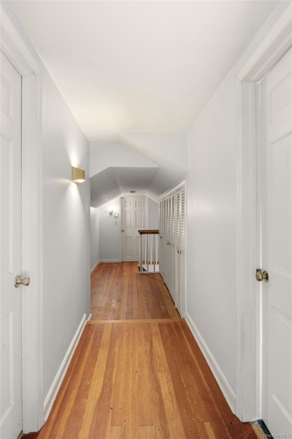 8 Old Wood Road Stony Brook, NY 11790 - Photo 20 of 50 Hall with wood-type flooring and vaulted ceiling