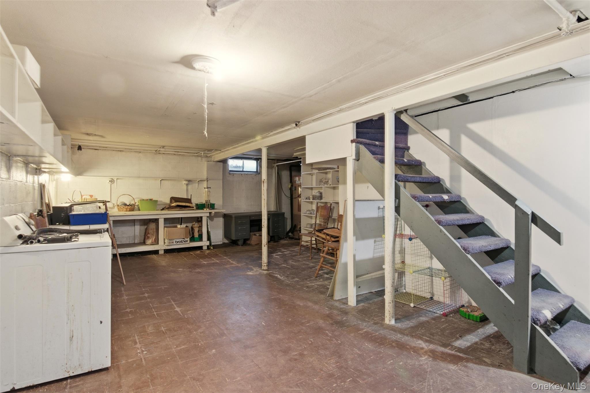8 Old Wood Road Stony Brook, NY 11790 - Photo 21 of 50 Below grade area featuring stairs, washer / dryer, and dark flooring