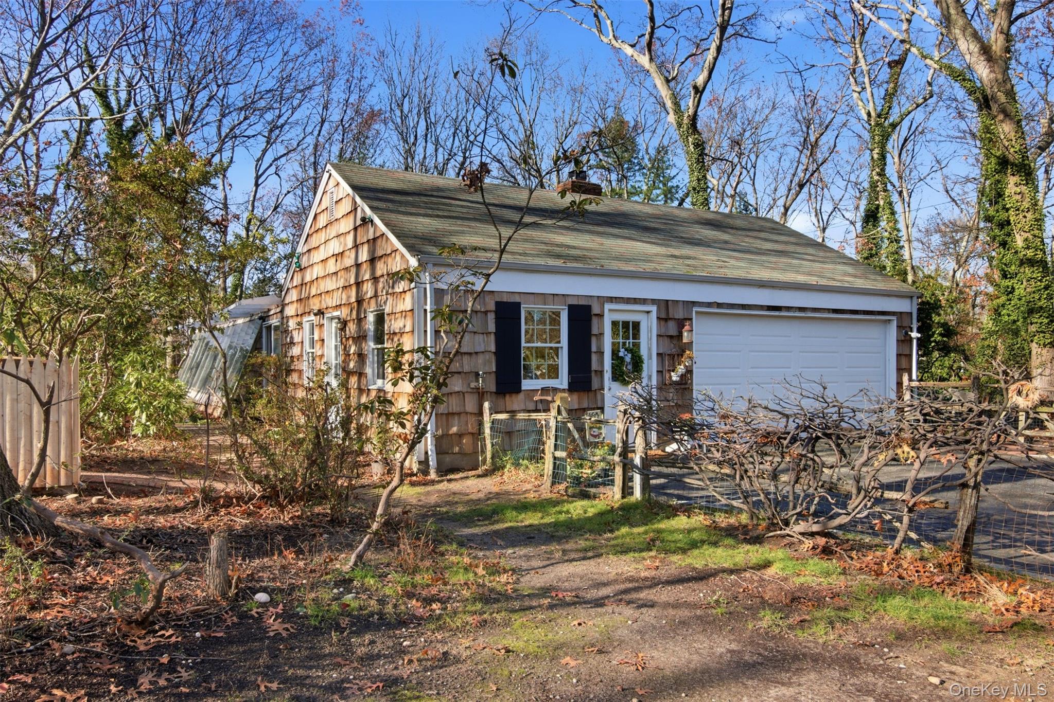 8 Old Wood Road Stony Brook, NY 11790 - Photo 32 of 50 View of front of home with roof with shingles, a chimney, and an attached garage