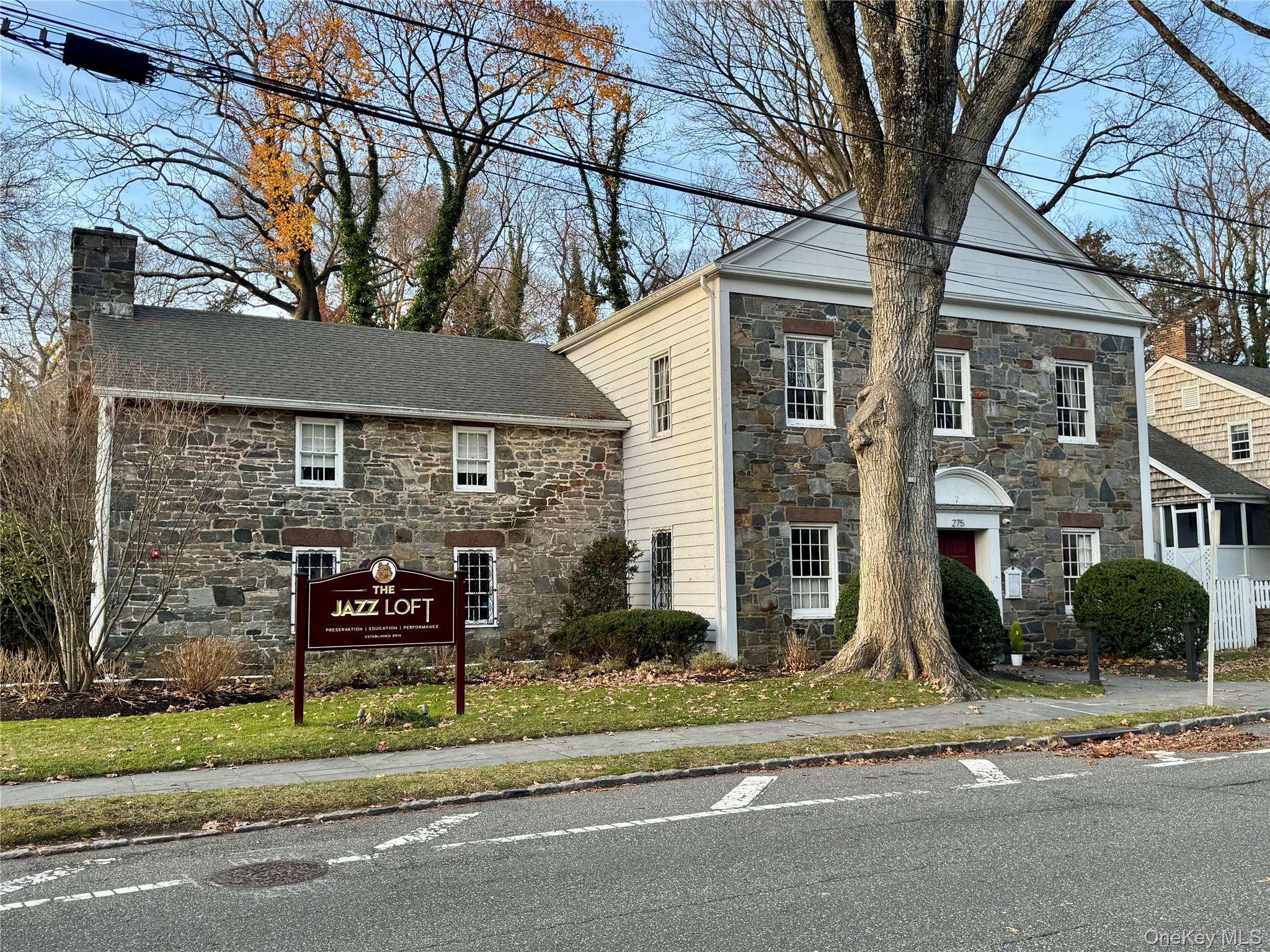 8 Old Wood Road Stony Brook, NY 11790 - Photo 45 of 50 View of front of house with stone siding and a chimney