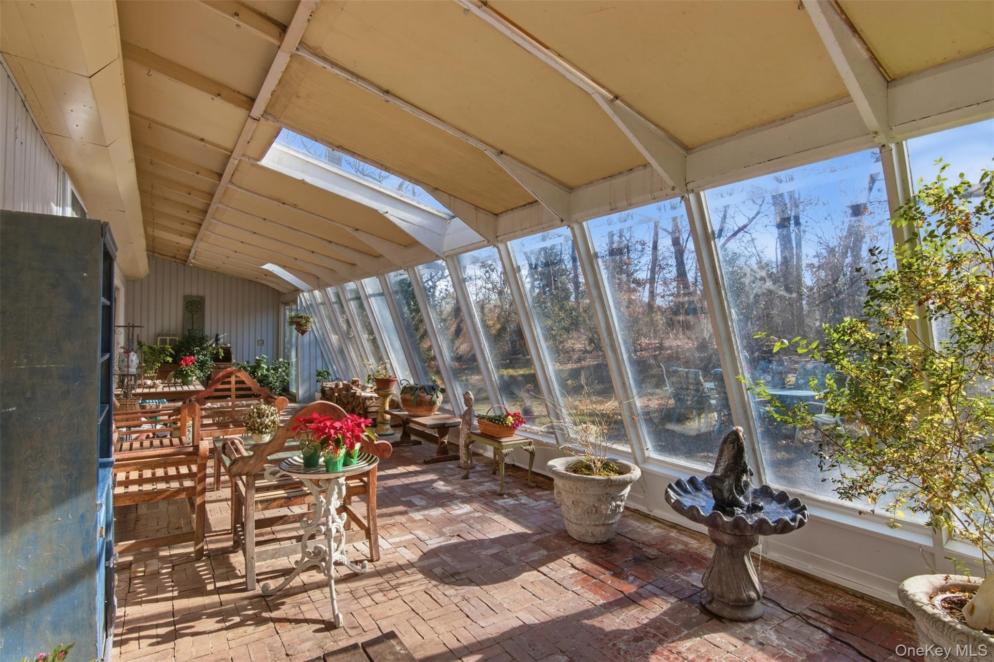 8 Old Wood Road Stony Brook, NY 11790 - Photo 10 of 50 Sunroom / solarium with brick floors, lofted ceiling, and a skylight