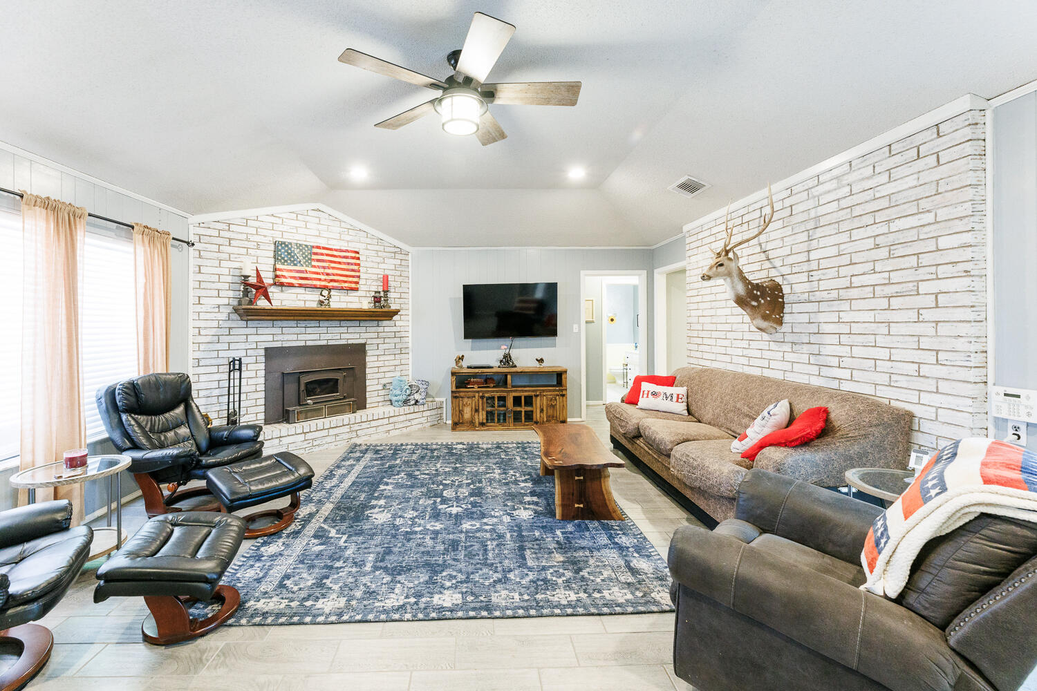 705 Grace Street Brownfield, TX 79316 - Photo 12 of 43 a living room with furniture fireplace and flat screen tv