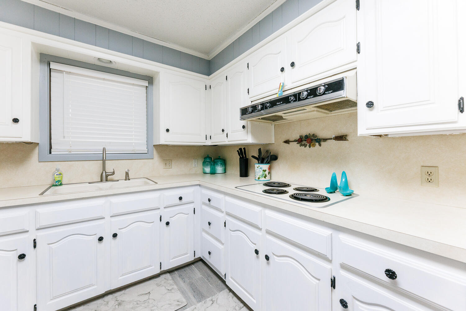 705 Grace Street Brownfield, TX 79316 - Photo 18 of 43 a kitchen with stainless steel appliances white cabinets and white appliances
