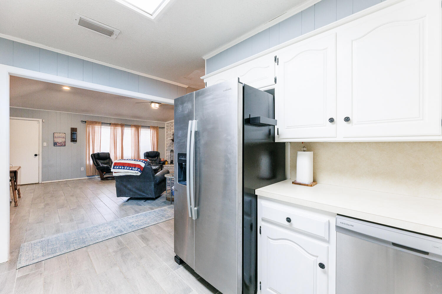 705 Grace Street Brownfield, TX 79316 - Photo 21 of 43 a kitchen with a refrigerator and a sink