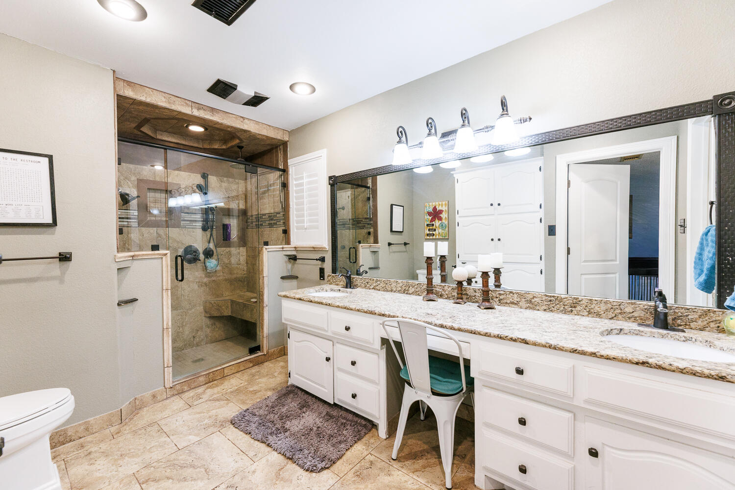 705 Grace Street Brownfield, TX 79316 - Photo 25 of 43 a spacious bathroom with a granite countertop sink mirror and toilet