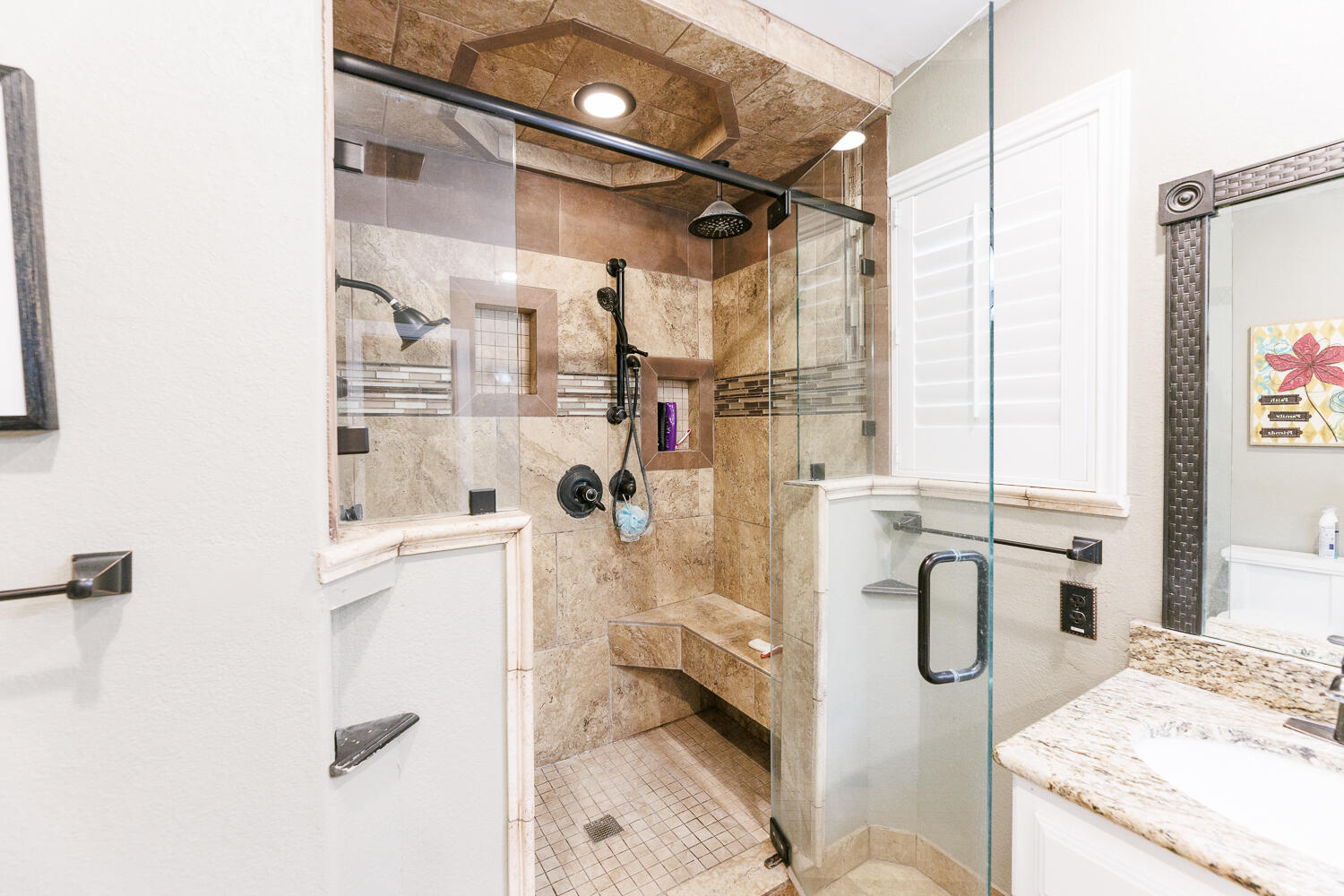 705 Grace Street Brownfield, TX 79316 - Photo 26 of 43 a bathroom with a granite countertop sink a toilet and shower