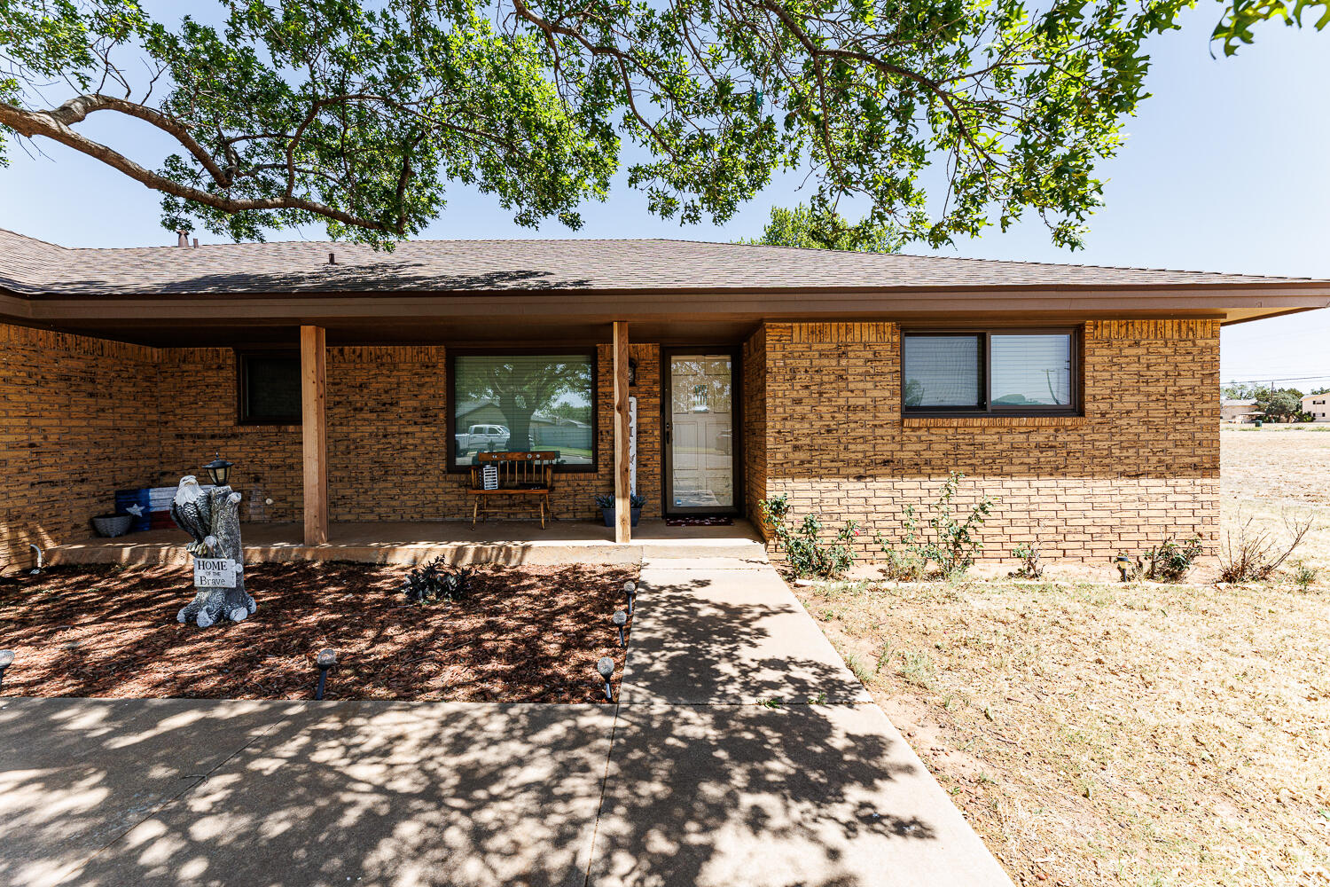 705 Grace Street Brownfield, TX 79316 - Photo 3 of 43 a front view of a house with a tree