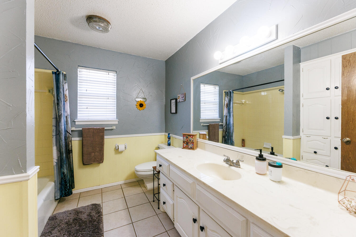 705 Grace Street Brownfield, TX 79316 - Photo 31 of 43 a bathroom with a sink a toilet and mirror