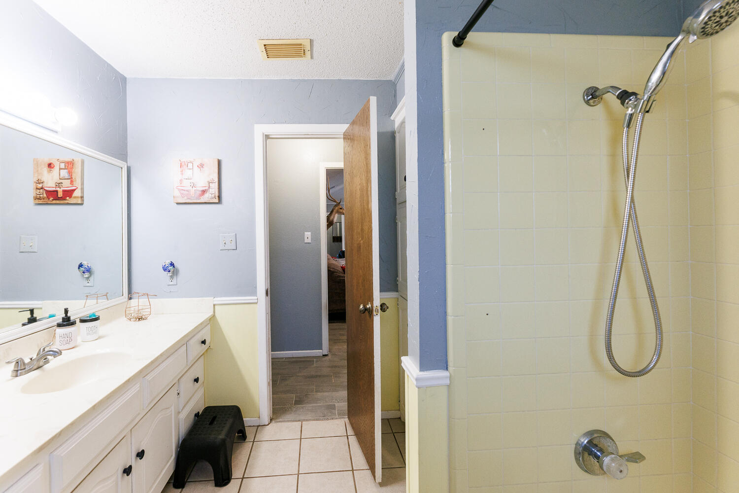 705 Grace Street Brownfield, TX 79316 - Photo 33 of 43 a bathroom with a double vanity sink a vanity and shower