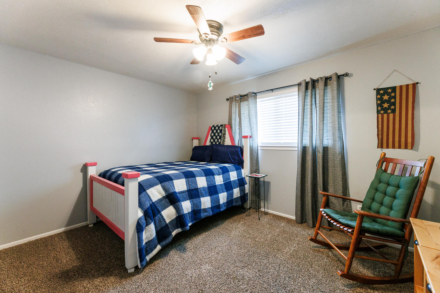 705 Grace Street Brownfield, TX 79316 - Photo 34 of 43 a bedroom with a bed and a chandelier